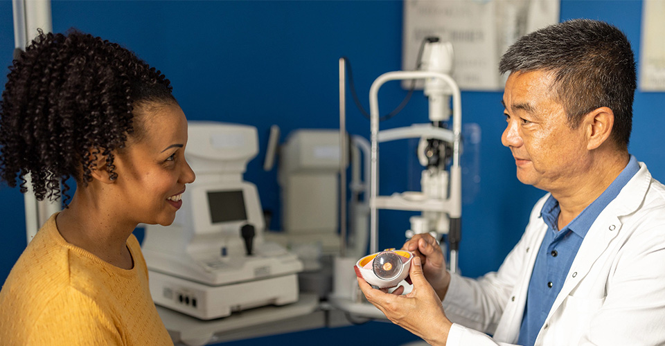 An eyecare professional helping a patient complete an eye exam