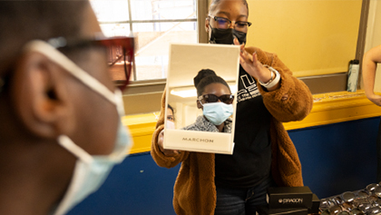 A women looking into a mirror with glasses on