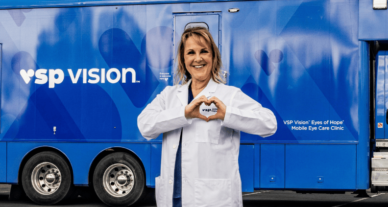 Dr. Kirschbaum in front of a VSP Eyes of Hope mobile clinic