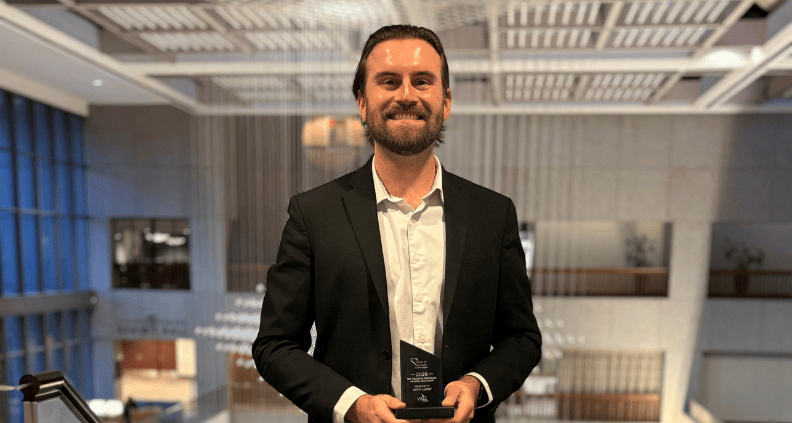 John Luder, winner of the 2026 Dr. Frank D. Fontana Memorial Scholarship, holding up award trophy